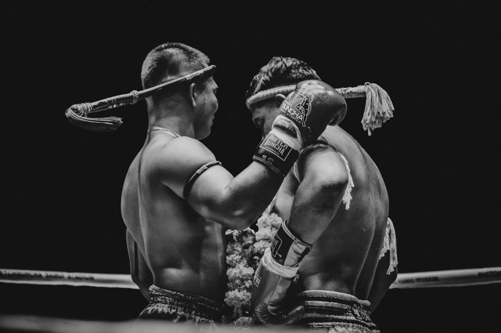 Mauy Thai Black and white photo of two Muay Thai fighters in a ring, showcasing the intensity of the sport.