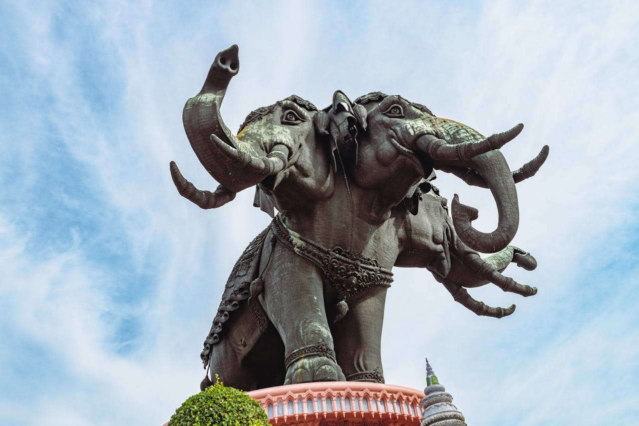 our-experience Majestic elephant statue at Erawan Museum in Bangkok, Thailand against a clear blue sky.