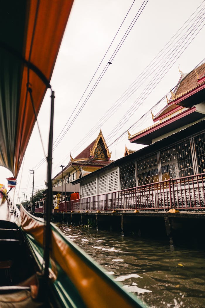 Explore Bangkok's canals with traditional Thai architecture along the waterway. A unique cultural experience.